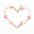 Heart with pink flowers and candy confetti on white background. Flat lay, Top view. Valentine`s day composition Royalty Free Stock Photo