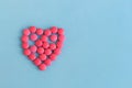 Heart from pink pills on blue background Royalty Free Stock Photo