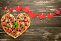 Heart pizza love concept Valentines day romantic dinner Italian pastry with red hearts. on a wooden table. Flat-lay