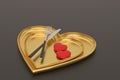 Heart plate with knife and fork on black background. 3D illustration