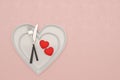 Heart plate with knife and fork on pink background. 3D illustration