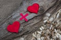 Heart plus heart. Two red toy hearts on natural burlap background, lovers together and forever idea Royalty Free Stock Photo