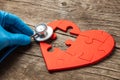 Heart puzzle red and stethoscope on wooden background. Concept diagnosis and treatment of heart disease, medical insurance Royalty Free Stock Photo