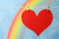 The heart symbol with a blue sky and colorful rainbow.