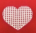 heart on a red background. knitted fabric with a pattern. Royalty Free Stock Photo