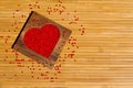 Heart from red beads in wooden heart-shaped box