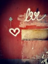 Heart on a red concrete wall. Symbol of love. Graffiti.