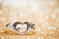 Heart ring on the floor with golden bokeh on background Royalty Free Stock Photo