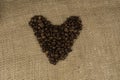 Heart with roasted coffee beans on the burlap Royalty Free Stock Photo