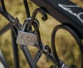 Heart rusty old pad lock on a metal black fence. Symbolism padlock for lovers. Pad lock hangs on the fence. K+O. Royalty Free Stock Photo