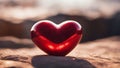 heart on the sand A red stone heart with a shine on it. The heart is smooth and polished, and the shine is a sign of love Royalty Free Stock Photo