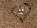 Heart in the sand. Sea background. Sea stones Royalty Free Stock Photo