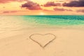 Heart on sand on tropical beach at sunset Royalty Free Stock Photo