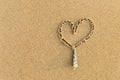 Heart and seashell on fine sandy beach background, love summer on the beach Royalty Free Stock Photo
