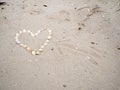 Heart from seashells with arrow in the sand Royalty Free Stock Photo