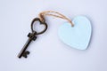 Heart shape antique key with pastel blue wooden heart keyring. Home sweet home concept