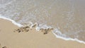 Heart shape with arrow on sand that wiped off by sea wave