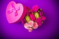 Heart shape box with berry pink spring color macaroons background with love