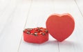 Heart shape box with red roses inside on white wood table top ,L Royalty Free Stock Photo