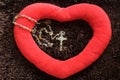 Heart shape on brown background with rosary beads and Jesus Christ holy cross crucifix. Love, pray and hope concept with rosary.