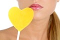 Heart shape candy on woman macro mouth Royalty Free Stock Photo