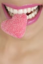 Heart shape candy on woman macro mouth Royalty Free Stock Photo