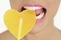 Heart shape candy on woman macro mouth Royalty Free Stock Photo