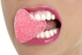 Heart shape candy on woman macro mouth Royalty Free Stock Photo