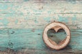 Heart shape carved in wood cut on the old turquoise boards. Royalty Free Stock Photo