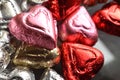 Heart shape chocolate candy red, pink, gold foil wrapped pieces Royalty Free Stock Photo