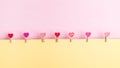 Heart shape clothespin with yellow and pink background Royalty Free Stock Photo