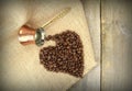 Heart shape with coffee beans and traditional Turkish copper coffee pot on a burlap Royalty Free Stock Photo