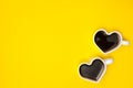 Heart shape coffee cup over yellow background. View from above. Royalty Free Stock Photo