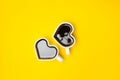 Heart shape coffee cups over yellow background. View from above. Royalty Free Stock Photo