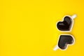 Heart shape coffee cups over yellow background. View from above. Royalty Free Stock Photo