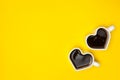 Heart shape coffee cups over yellow background. View from above. Royalty Free Stock Photo