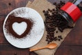 Heart Shape coffee powder on a white plate with coffee beans Royalty Free Stock Photo