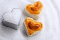 Heart shape cookies with cashew nut or Singapore Cookie on the pile white granulated sugar for valentines day element concept Royalty Free Stock Photo