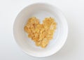 Heart shape cornflake in white bowl isolated