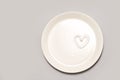 Heart shape cream. Beauty lotion. Mayonnaise smear on white plate