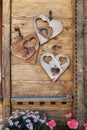 Heart shape decos hanging on a rustic wooden door
