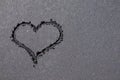 Heart shape drawn on black sand beach Royalty Free Stock Photo