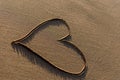 Heart shape drawn in the sand on a beach Royalty Free Stock Photo