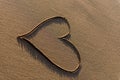 Heart shape drawn in the sand on a beach Royalty Free Stock Photo