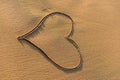 Heart shape drawn in the sand on a beach Royalty Free Stock Photo