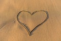 Heart shape drawn in the sand on a beach Royalty Free Stock Photo