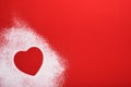 Heart shape frame made of flour on red background. Happy Valentines day, mothers day. Valentines day gift bakery concept for card