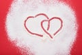 Heart shape frame made of flour on red background. Happy Valentines day, mothers day. Valentines day gift bakery concept for card