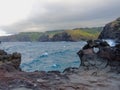 Heart shape geological formation naturally occurring in lava rock wall at Nakalele in Hawaii, USA, with ocean and Maui Mountains i Royalty Free Stock Photo