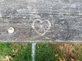Heart shape graffiti carved in wood table